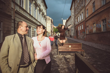 Father and his daughters walking in the old town