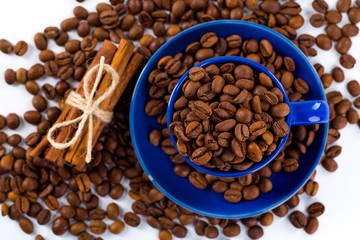 Cup of coffee and beans with delicious macaroon on a white backg