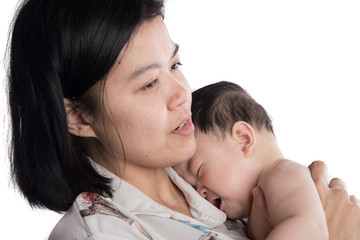 ASain mother holding little crying baby infant with love