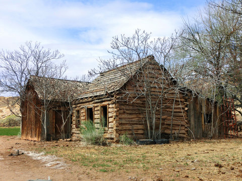 Abandoned old weathered log cabin in American desert
