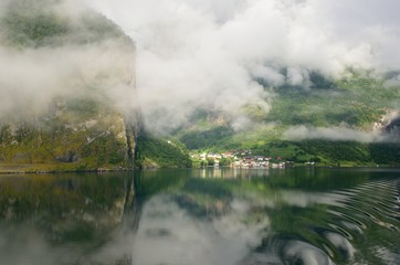 Fototapeta na wymiar Small Norwegian village with calm waters