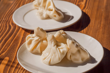 Some plates with Khinkali. Georgian dumpling with meat, or cheese, or mushrooms, potato. Traditional Caucasian cuisine