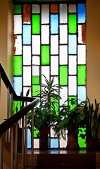 Stained glass window and plant pots on the stairs