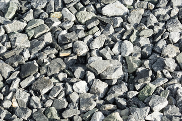 Grey rocks in the evening light. Pavement for laying asphalt.