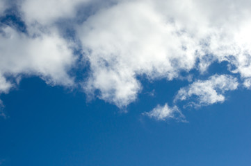 Evening clouds on the background of the blue sky.