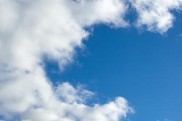 Evening clouds on the background of the blue sky.