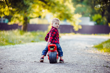 Little boy on a children's bike in the park