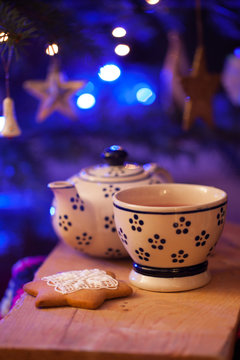 Christmas sweets baking gingerbread cookies on the plate. Decorated for Christmas gingerbread cookies, christmas figurines bumps. Christmas cookies gingerbread on blue table, tea drink.