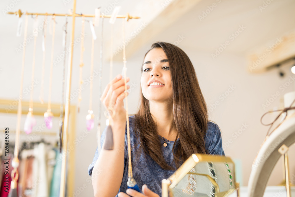 Wall mural young woman looking at a price tag