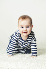Cute Baby Girl. Small Child Wearing Striped T-Shirt