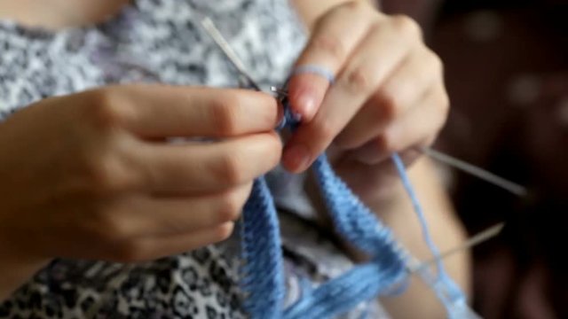 Pregnant woman crocheting for baby during pregnancy. Crochet, knitting process