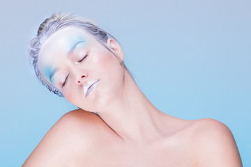 Naklejka premium Model in creative image with silver blue artistic make-up