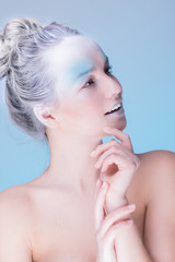 Model in creative image with silver blue artistic make-up