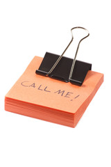 post-it note with clip and message call me on white background