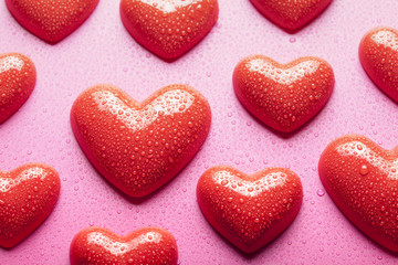 Obraz premium Red hearts on pink background