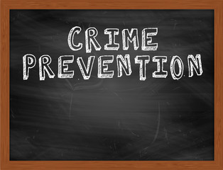 CRIME PREVENTION handwritten text on black chalkboard