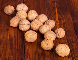 Whole walnuts close-up on background dark wood.