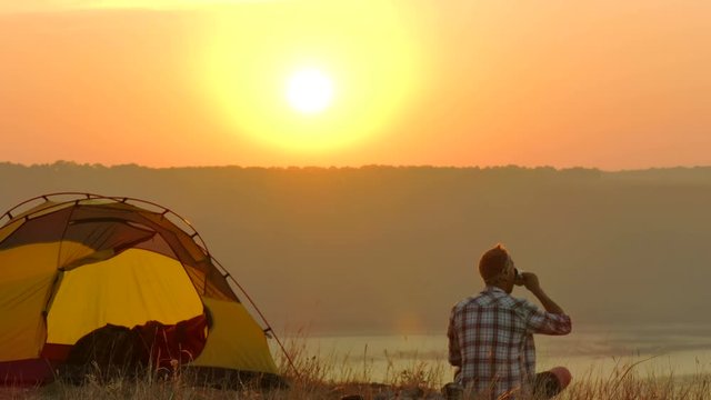 
4K  Sunrise, lake and man traveller photographs on  smartphone


