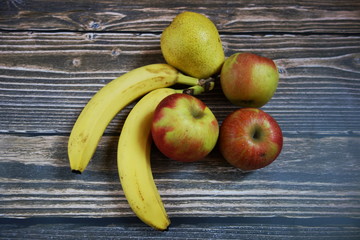 Fruits on wooden background, healthy vegetarian food ingredients, view from overhead 