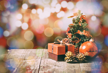 Christmas tree on wooden table and red bokeh background