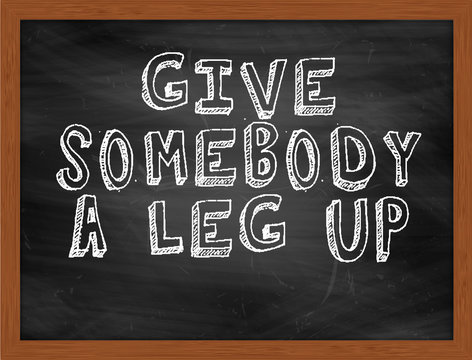 GIVE SOMEBODY A LEG UP Handwritten Text On Black Chalkboard