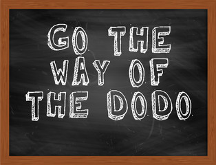 GO THE WAY OF THE DODO handwritten text on black chalkboard © Ionut  Catalin Parvu