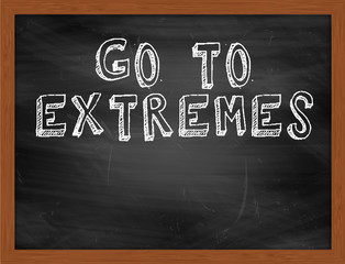 GO TO EXTREMES handwritten text on black chalkboard