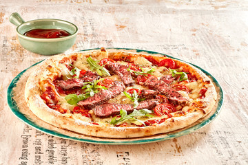 Marinated beef slices on freshly baked pizza