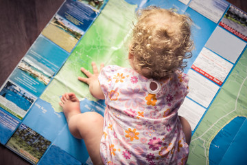 Child exploring map for holiday planning