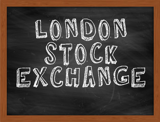 LONDON STOCK EXCHANGE handwritten text on black chalkboard