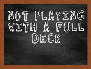 NOT PLAYING WITH A FULL DECK handwritten text on black chalkboar