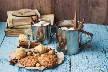 Metal mugs with cacao and marshmallows