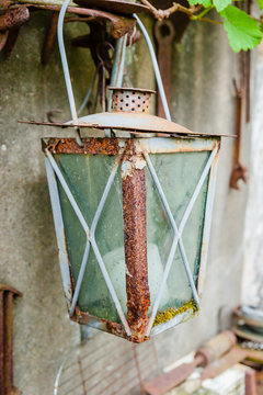 Close-up of red rusty vintage lantern hanging.