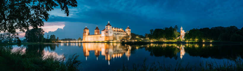 Fototapeta na wymiar Belarus. Panoramic View Of Mir Castle Complex In Evening Illumin