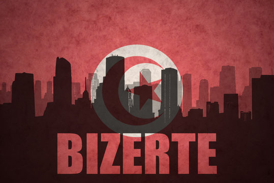 abstract silhouette of the city with text Bizerte at the vintage tunisian flag