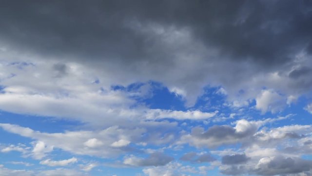 Flow of Clouds in the Blue Sky. Majestic clouds illuminated by the sun. Timelipse