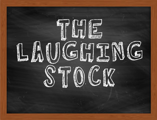 THE LAUGHING STOCK handwritten text on black chalkboard