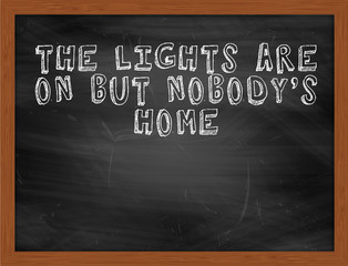 THE LIGHTS ARE ON BUT NOBODYS HOME handwritten text on black cha