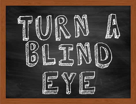 TURN A BLIND EYE Handwritten Text On Black Chalkboard