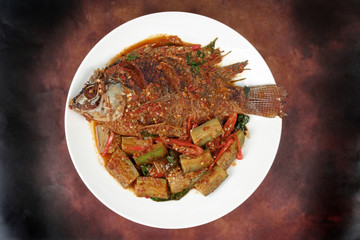 Deep-fried tilapia fish topped Spicy fried eggplant.