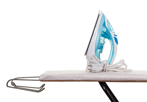 Electric steam iron and ironing board isolated on white.