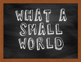 WHAT A SMALL WORLD handwritten text on black chalkboard