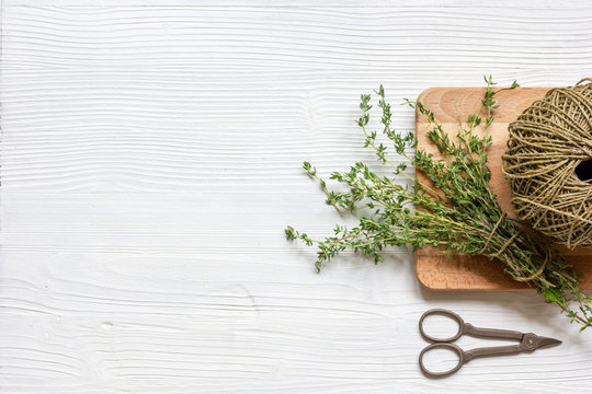 fresh herbs preparation to be dried top view wooden background