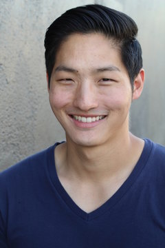 Portrait of a handsome Asian man smiling and laughing 