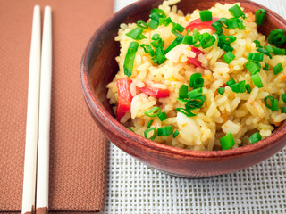 Wooden bowl of cooked rice with vegetables