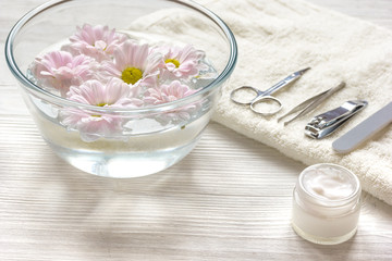 Fototapeta na wymiar manicure set and hand cream on wooden background