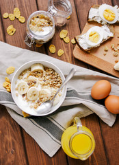 healthy breakfast bowl of yogurt with granola and eggs
