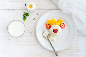 Ice cream with berries on white plate top view