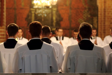 The young clerics of the seminary during Mass - obrazy, fototapety, plakaty