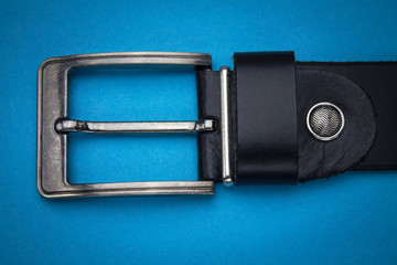 black belt leather on blue background